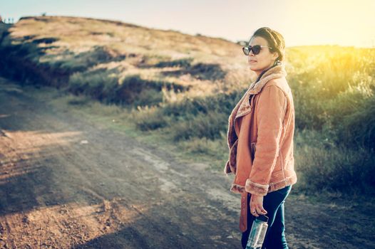 Close-up of a young woman on the road, Lifestyle of a Latin girl on a road outdoors. Portrait of a young woman on a road, woman on a road. Latina girl woman concept on a dirt road