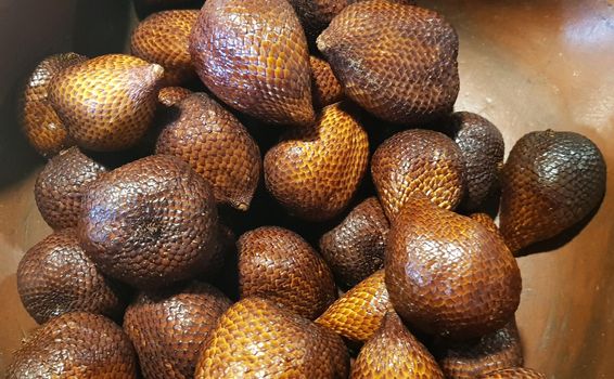 group of snake fruit or called salak in local indonesian language is a type of palm fruit commonly eaten also known as sala, the scientific name is Salacca zalacca.
