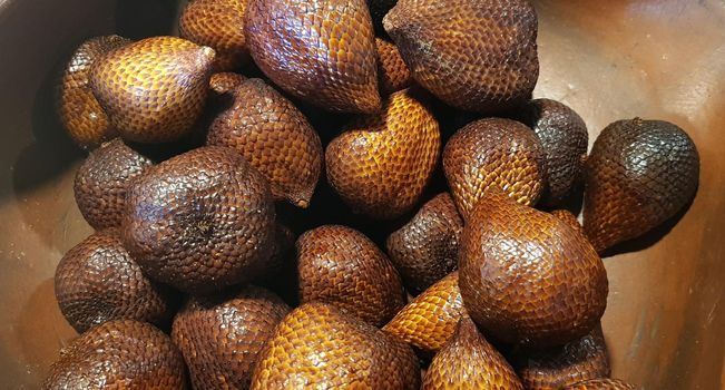 group of snake fruit or called salak in local indonesian language is a type of palm fruit commonly eaten also known as sala, the scientific name is Salacca zalacca.