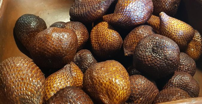 group of snake fruit or called salak in local indonesian language is a type of palm fruit commonly eaten also known as sala, the scientific name is Salacca zalacca.