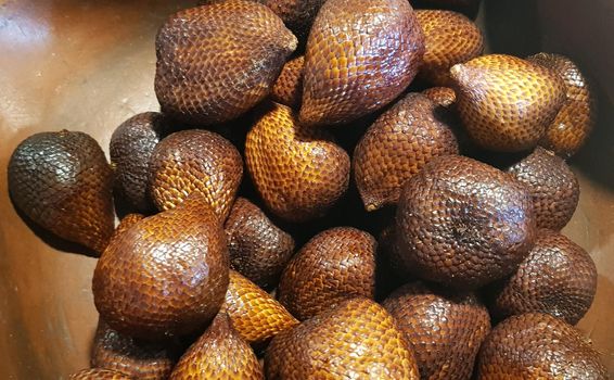 group of snake fruit or called salak in local indonesian language is a type of palm fruit commonly eaten also known as sala, the scientific name is Salacca zalacca.