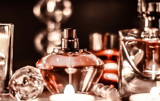 Perfumery, cosmetics branding and luxe concept - Perfume bottle and vintage fragrance on glamour vanity table at night, pearls jewellery and eau de parfum as holiday gift, luxury beauty brand present