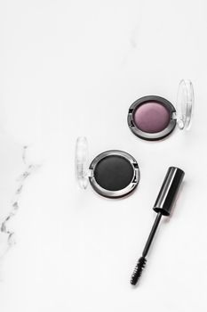 Cosmetic branding, blog and girly concept - Eyeshadows, black liner and mascara on marble background, eye shadows cosmetics as glamour make-up products for luxury beauty brand, holiday flatlay design