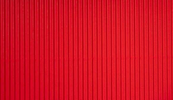 Decorative background. Background texture of corrugated red cardboard.