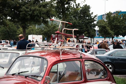 Genk, BELGIUM, August 18, 2021: classic summer meet of oldtimer at The Luminus Arena Genk, red and grey volkswagen beetle, High quality photo