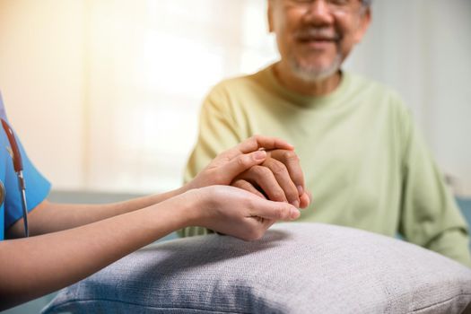 International Day for the Elderly. Caring nurse helping elderly old man care facility gets help from hospital, young woman helping hands offering her senior man at home, old aged