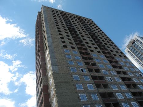 Building under construction against blue sky.