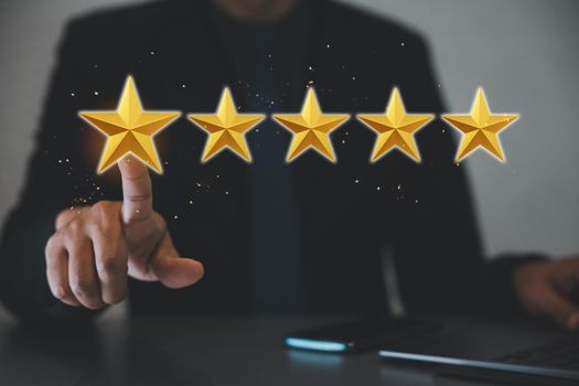 Gold five stars rating quality review. Businessman pointing finger to five star symbol for best service internet marketing, The man touching increase excellent rating of company for good service