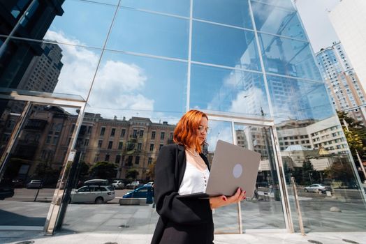 Smiling female looking at her laptop outdoors, modern lifestyle, connection, business, coffee break, communication, web chat, social media, video conference concept.