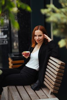 Beautiful woman working on laptop at outdoors cafe