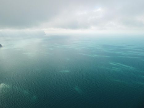 Aerial panoramic view of beautiful sunset above sea. Beautiful seascape. Sun glare, small waves on the water surface. Evening. Horizon. Nobody. No people. Copy space. Never-ending beauty of nature