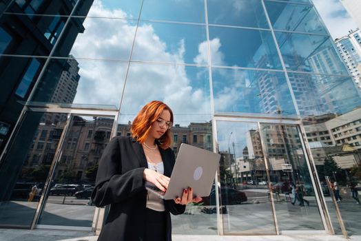 Smiling female looking at her laptop outdoors, modern lifestyle, connection, business, coffee break, communication, web chat, social media, video conference concept.