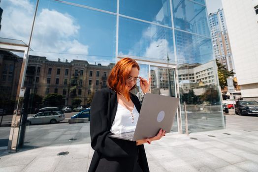 Smiling female looking at her laptop outdoors, modern lifestyle, connection, business, coffee break, communication, web chat, social media, video conference concept.