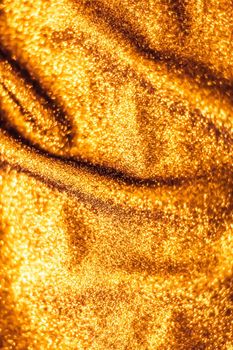 Luxe glowing texture, night club branding and New Years party concept - Golden holiday sparkling glitter abstract background, luxury shiny fabric material for glamour design and festive invitation