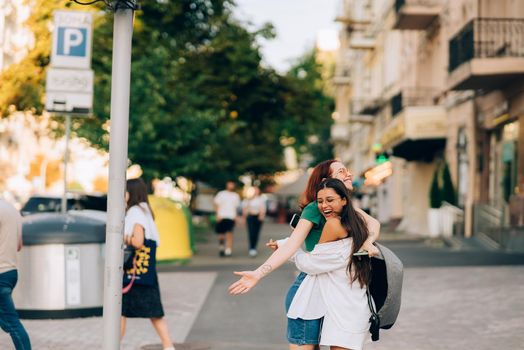 Meeting of two friends hugging in the street