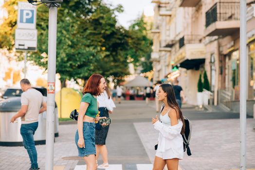 Young women talking and laughing at the city street