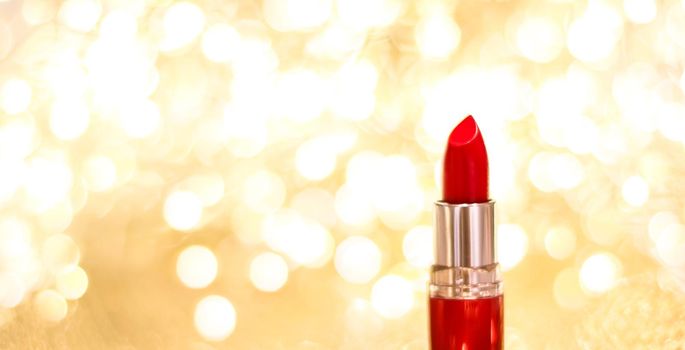 Cosmetic branding, sale and glamour concept - Red lipstick on golden Christmas, New Years and Valentines Day holiday glitter background, make-up and cosmetics product for luxury beauty brand