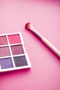 Cosmetic branding, mua and girly concept - Eyeshadow palette and make-up brush on pink background, eye shadows cosmetics product as luxury beauty brand promotion and holiday fashion blog design