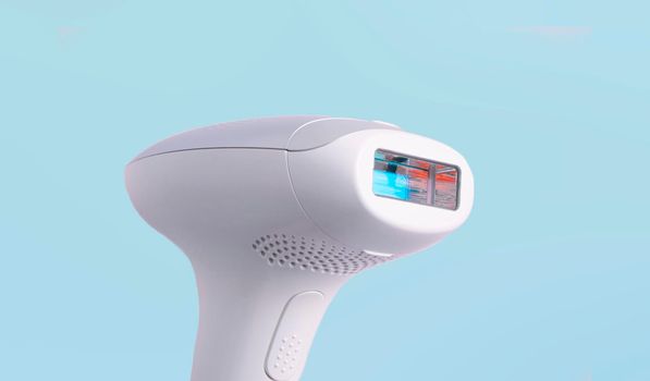 home modern laser epilator. Hair Remover offering Permanently Smooth Skin. Flash Epilator Laser on a pink background. Female blog concept. Photoepilator for home use. selective focus. close-up.