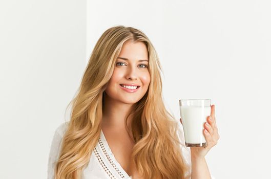 Diet, health and wellness concept, woman holding glass of milk or protein shake cocktail