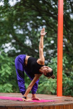 Morning workout. Healthy lifestyle concept. Young attractive woman in sportswear does stretching hand before exercise. Warm up