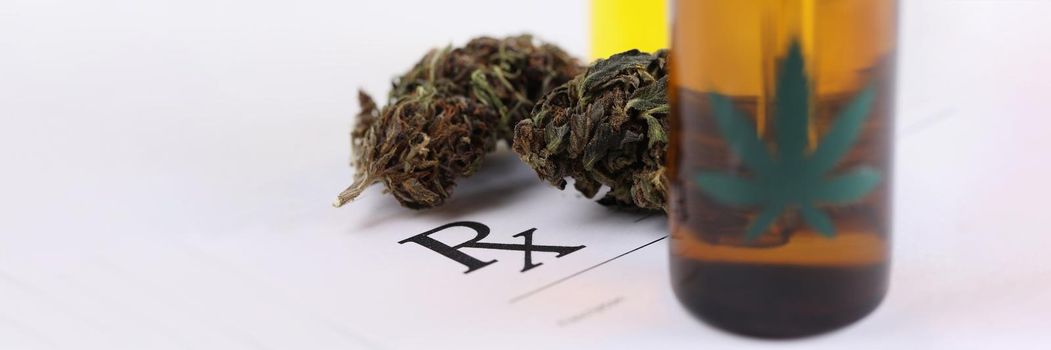 Close-up of medicinal cannabis with extract oil in bottle on prescription paper. Alternative medicine, meds, health, treatment for healing, cbd concept