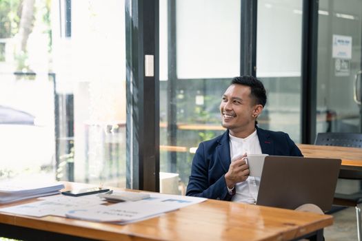 Portrait business man using laptop computer on work desk at office