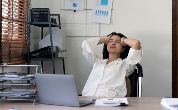 Tired business accountant woman feel headache. stressed working woman at business desk in a business office.