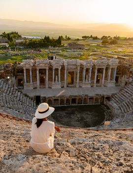 Hierapolis ancient city Pamukkale Turkey, sunset by the ruins Unesco site, Hierapolis ancient city Pamukkale Turkey Young Asian women with hat watching the sunset at Hierapolis Pamukkale