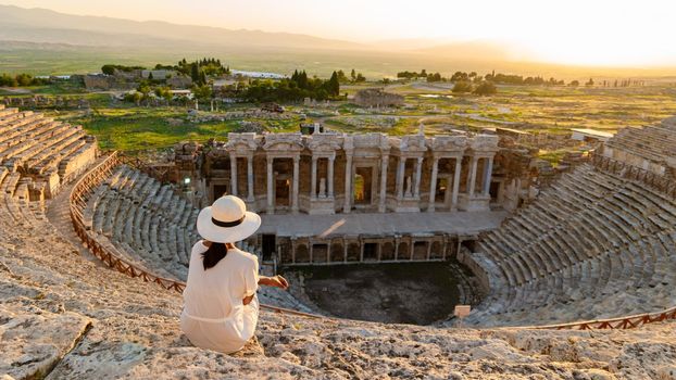 Hierapolis ancient city Pamukkale Turkey, sunset by the ruins Unesco site, Hierapolis ancient city Pamukkale Turkey Young Asian women with hat watching the sunset at Hierapolis Pamukkale