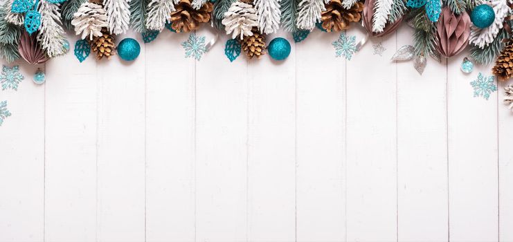 Christmas banner with composition from pine, cones, balls on wooden background top view, flat lay. Copy space.