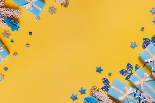 Christmas flat lay composition from gifts, paper balls and tinsel top view. Ukrainian yellow blue colors. Copy space.
