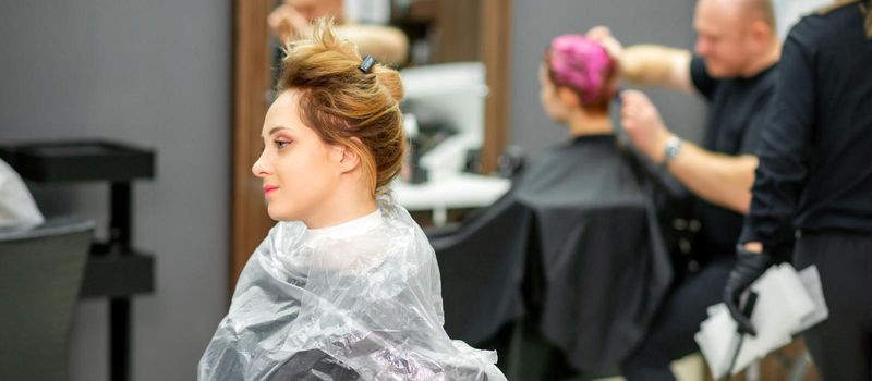 Beautiful young blonde caucasian woman in the modern hair salon