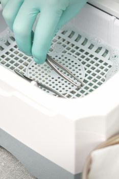 Hand disinfects tweezers with cleaning systems for medical instruments. Ultrasonic cleaner