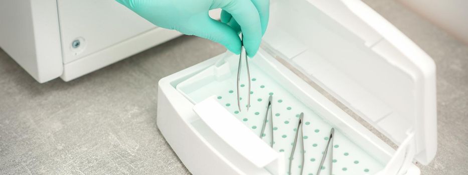Hand disinfects tweezers with cleaning systems for medical instruments. Ultrasonic cleaner