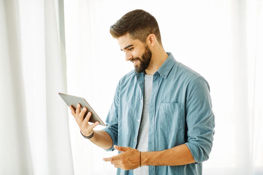 Portrait of a young man with a tablet