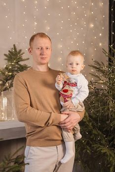 Dad and his little son in a magical Christmas atmosphere. The concept of family relations and New Year celebrations