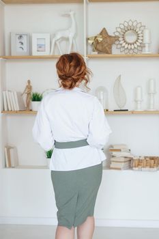 Tver, Russia-July 31, 2022 A business woman with a book on Human Design in her hands. A human design specialist works at home. Working at home during the epidemic.