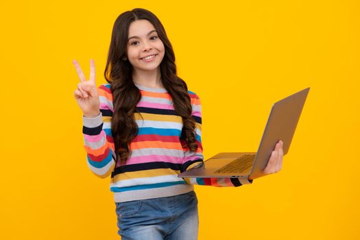 Teenager school girl hold notebook laptop. School children on isolated studio background. Happy teenager, positive and smiling emotions of teen schoolgirl