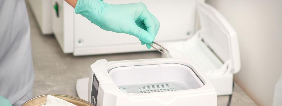 Hand disinfects tweezers with cleaning systems for medical instruments. Ultrasonic cleaner