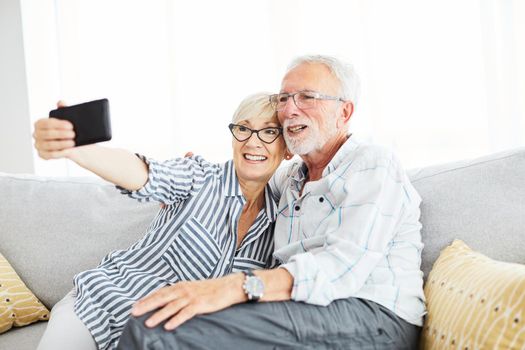 portrai of senior couple taking selfie