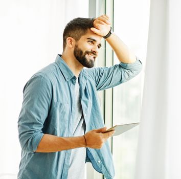 Portrait of a young man with a tablet