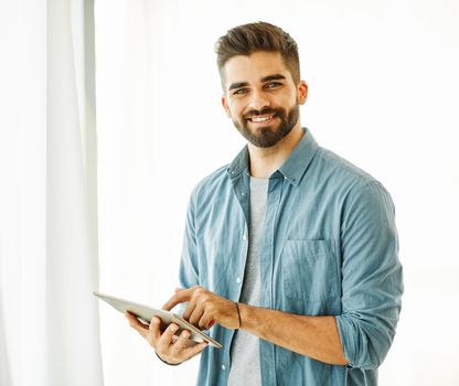 Portrait of a young man with a tablet