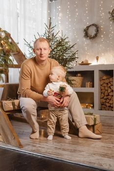 Dad and his little son in a magical Christmas atmosphere. The concept of family relations and New Year celebrations