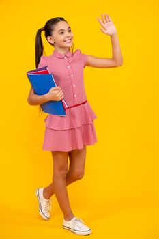 Teenager school girl with books isolated studio background. Happy teenager, positive and smiling emotions of teen girl