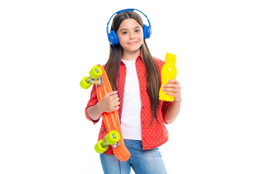 Beautiful and fashion young teen girl posing with skateboard and headphones. Teenager street fashion lifestyle