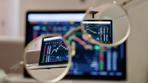 Laptop buy bitcoin on the Binance crypto exchange in glasses. Trading, spot, staking. Workspace freelance flatlay