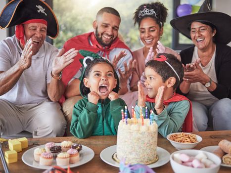 Happy, birthday and party with family in costume for celebration event in living room for love, creative or halloween holiday. Excited, funny and smile with kids, parents and grandparents at home.