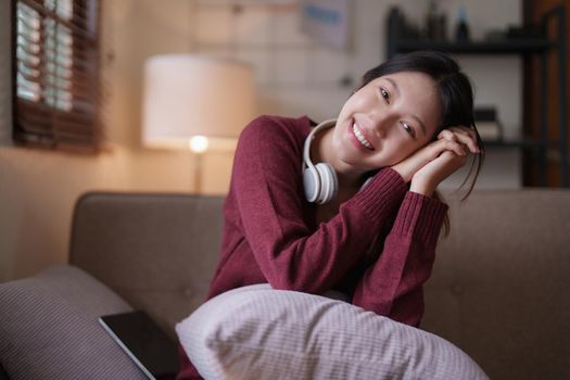 Young asian woman happy life sitting on couch cozy living room at home. The house was homely concept.