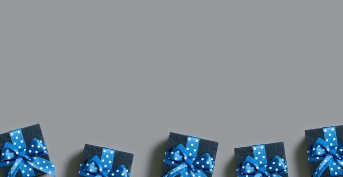 Banner with Black gift boxes with bow flat lay on grey background. View from above. Copy space.